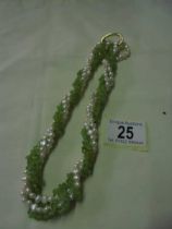 A green coral and natural pearl necklace.