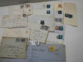 A collection of 19th century stamps on envelopes including two penny blues.