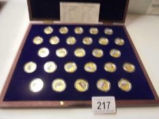 A limited edition cased set of 27 gold plate on copper commemorative coins.