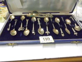 A cased set of 12 decorative tea spoons and six other.