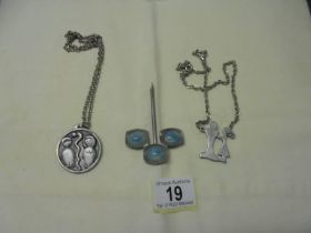 Three Jorgen Jensen pewter jewellery items.