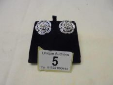 A large pair of platinum and diamond earrings (centre stones 25pt), 9 grams.