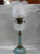 A Victorian brass and metal oil lamp with opaque glass font, Duplex burner and later shade. COLLECT