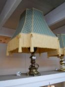 A good quality brass and wood table lamp with fringed shade.