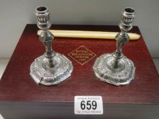 A boxed pair of Selangor pewter candlesticks.