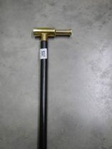 A modern walking stick with brass telescope as the handle.