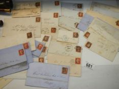 Approximately 40 penny red stamps on postmarked envelopes.