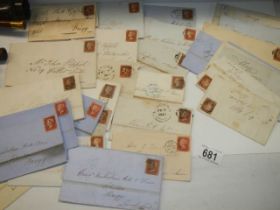 Approximately 40 penny red stamps on postmarked envelopes.