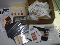 A box of stamps including penny reds, leaves, GB, Commonwealth, world etc.,