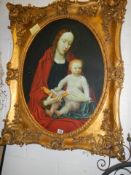 A gilt framed oval oil on canvas painting of Madonna with child, frame 104 x 85 cm, image 78 x 57 cm