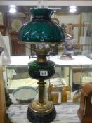 A Victorian brass oil lamp with green glass font and green glass shade, COLLECT ONLY.