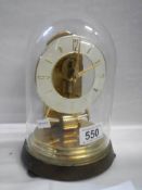 A Kieninger & Kunergtell battery clock under dome made in West Germany COLLECT ONLY.