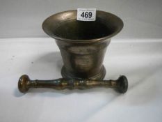 A 19th century bronzed pestle and mortar.