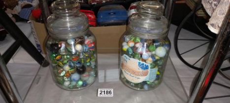 2 glass jars of marbles