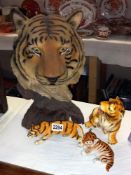 A large resin sculpture of a tiger and 3 china figures of tigers