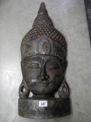 Impressive large carved wooden Sukothai Buddha head with decorative inlay and gilt highlights.