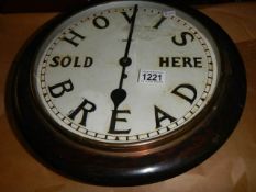 A wall clock with Hovis advertising.