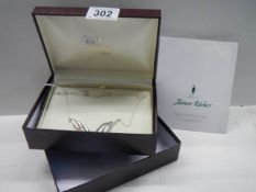 A boxed James Usher silver necklace.
