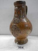 A 'Bachanalian' salt glaze jug (possibly 18th century). This is a Bellarmine jug.