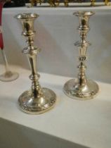 A pair of Sheffield plate candlesticks.