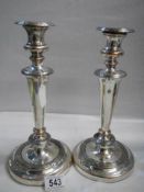 A pair of silver plate on copper candlesticks.