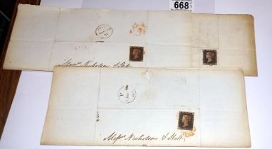 Three mid 19th century penny black postage stamps on postmarked envelopes.