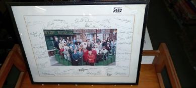 A 1990's framed and glazed signed picture of the cast from Coronation Street