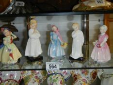 Five Royal Doulton figurines.