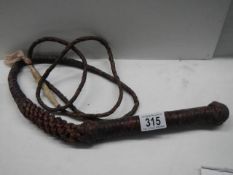 A very old horse whip in good condition.