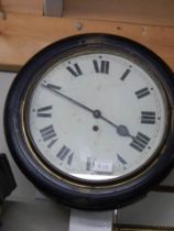 A circular mahogany school clock, in working order.