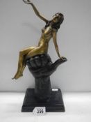 A bronze nude figure sat on a clenched hand on a marble base marked Juno, 22.5 cm tall.
