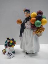Two Royal Doulton figurinesm - The Old Balloon Seller HN2129 and Biddy Penny Farthing HN1843.