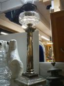 A Victorian silver plate Corinthian column oil lamp in good condition.