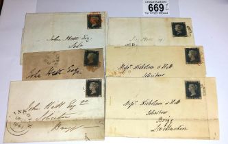 Six mid 19th century penny black postage stamps on postmarked envelopes.