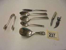 A silver caddy spoon, 3 silver spoons, silver sugar nips, silver book mark, silver penknife etc.,