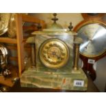 A green marble eight day mantel clock, in working order.