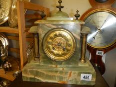 A green marble eight day mantel clock, in working order.