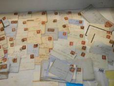 Approximately 65 penny red stamps on postmarked envelopes.