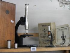 Two old cased microscopes.