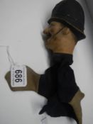 A vintage hand puppet of a policeman.