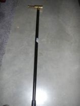 A walking stick with brass telescope handle.