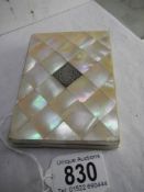 A mother of pearl wallet card case with silver cartouche.