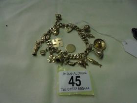 A 9ct gold charm bracelet with sixteen charms, 47.2 grams.