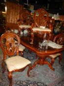 A superb quality carved table with eight chairs. COLLECT ONLY.