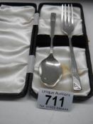 A cased silver spoon and fork set.