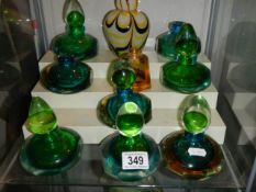 A mixed lot of coloured glass scent bottles etc.,