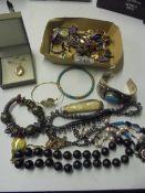 A box of assorted jewellery including some silver.