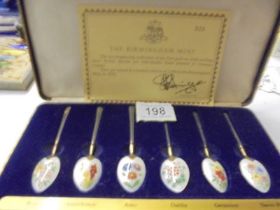 A cased set of The Birmingham Mint gold plate on silver floral enamel spoons.