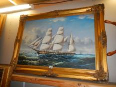 A gilt framed oil on canvas painting of a tall ship, frame 112 x 81 cm, image 90 x 60 cm. COLLECT