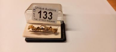 A 19th century pearl and sapphire brooch stamped Chester 15ct in fancy scroll work, 2.6 grams.